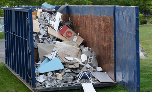 Vans and crew outside a house illustrating house clearance service